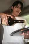 Romina pours San Juan. (16kb)